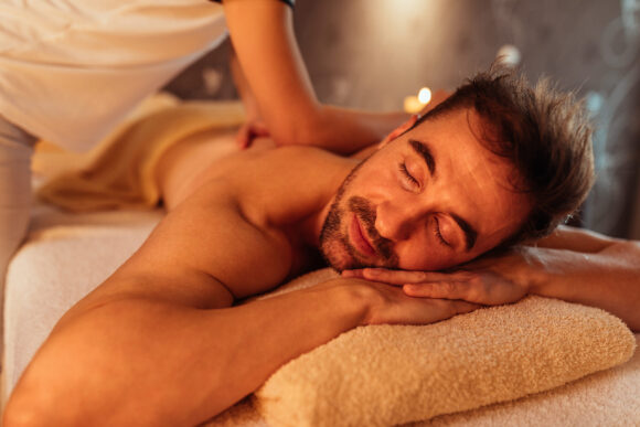 Cropped shot of a young man enjoying a massage at a spa